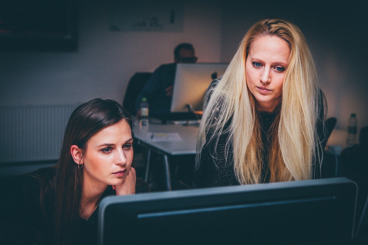 Woman working on computer with screen showing Google Analytics